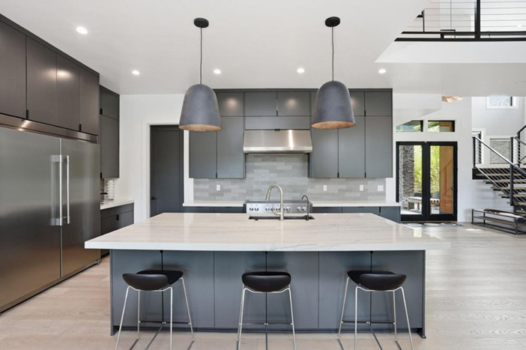 Contemporary kitchen with large island, pendant lighting and open-concept design in Central Oregon